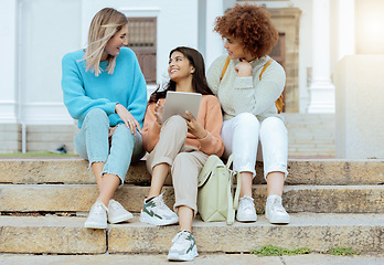 Image showing Student, friends and tablet on stairs in conversation, social media or communication at campus. Happy women enjoying discussion, chat or talking with touchscreen together on staircase at university