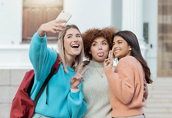 Image showing Women students, selfie and peace with hug at college campus for goals, comic and social network. Gen z woman, group and smartphone with funny face, happiness and studying at university for success