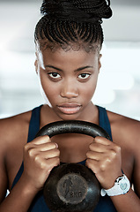 Image showing Fitness, portrait or black woman in gym with a kettlebell for strength training, exercise or workout. Motivation, face or healthy strong athlete with focus or weight for muscle development or growth