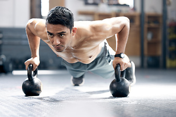 Image showing Fitness, push up or man with kettlebell for training, body workout or exercise at health club studio. Motivation, mindset or healthy Indian sports athlete exercising with focus or resilience at gym