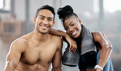 Image showing Portrait, fitness and diversity with a sports couple sitting in the gym together after a workout for health. Exercise, happy and strong with a man and woman athlete sitting in a training facility