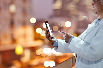 Image showing Doctor, hands and phone on balcony in the night city for communication, healthcare or advice. Hand of senior woman, medical expert or nurse in research, networking or chatting on mobile 5G smartphone