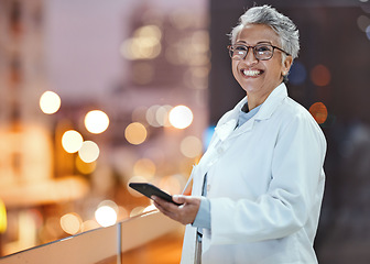 Image showing Phone, doctor and senior woman on hospital rooftop for telehealth, research or online consultation in city. Bokeh, healthcare portrait and female physician with smartphone for wellness app at night.