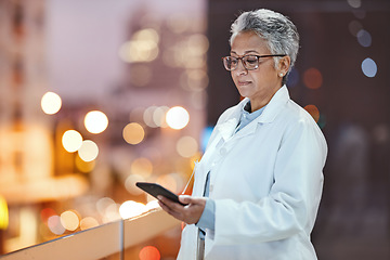 Image showing Doctor, phone and senior woman on hospital rooftop for telehealth, research or online consultation in city. Bokeh, healthcare and female medical physician with smartphone for wellness app at night