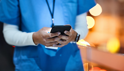 Image showing Doctor, phone and healthcare worker hands of a hospital employee at night on social media. Online consulting, mobile communication and wellness consultant woman at a clinic writing a text on web app