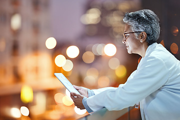 Image showing Tablet, senior woman and doctor on rooftop in hospital working on telehealth, research or online consultation in city. Bokeh, healthcare and female physician with technology for wellness app at night