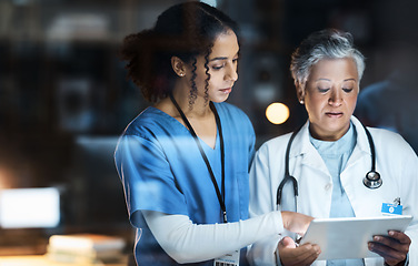 Image showing Women, doctors and tablet for night medical research, surgery planning and teamwork in hospital. Nurse, healthcare and worker collaboration on technology in late shift for wellness thinking and ideas