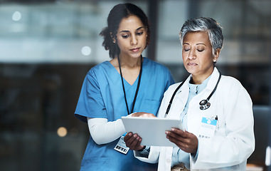 Image showing Doctors, women and digital tablet for night teamwork, medical research or surgery planning in wellness hospital. Thinking, healthcare and worker nurse in collaboration on technology for late schedule