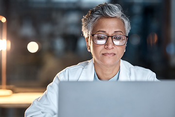 Image showing Woman, doctor and laptop in office at night at workplace, hospital or desk for medical career vision. Healthcare expert, dark clinic or focus for reading at computer, email or cancer research article