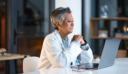 Image showing Doctor, laptop and senior woman in hospital working late or overtime on email, telehealth or research. Elderly, health and female medical physician reading healthcare information at night on computer