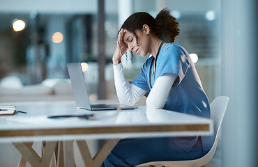 Image showing Headache stress, nurse and black woman in hospital feeling pain, tired or sick on night shift. Healthcare, wellness or female medical physician with depression or burnout while working late on laptop