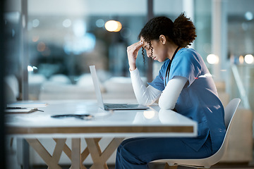 Image showing Nurse, headache stress and black woman in hospital feeling pain, tired or sick on night shift. Healthcare, wellness or female medical physician with depression or burnout while working late on laptop