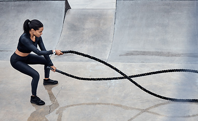 Image showing Fitness, battle ropes and strong with a black woman athlete outdoor for a workout from above. Exercise, energy and power with a female training outside using a heavy rope for cardio or endurance