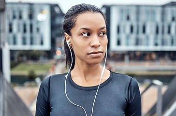 Image showing Music, fitness and face of black woman in city for wellness, healthy body and cardio workout in urban town. Sports, thinking and girl listening to audio for exercise, running and marathon training