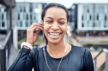 Image showing Music, fitness and face of black woman with smile in city for wellness, healthy body and cardio workout. Sports, headphones and girl listening to audio for exercise, running and marathon training