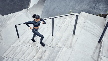 Image showing Training, above and woman running on stairs for power, sports and body energy in the city. Challenge, exercise and athlete runner with cardio on steps for a marathon, health and workout performance