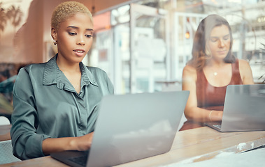 Image showing Laptop, working and business black woman in cafe window for networking, planning and writing email. Communication, internet and female workers typing on computer for project, ideas and remote work