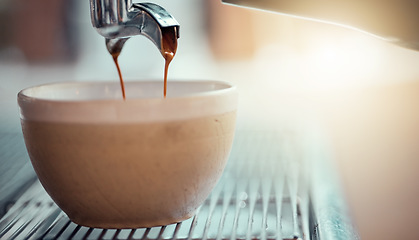 Image showing Coffee machine, cup and restaurant with a caffeine beverage or espresso being poured in the service industry. Kitchen, cafe and drink with the pouring of a latte on a countertop for preparation