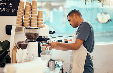 Image showing Coffee shop, machine and man barista working on a espresso or latte order in the restaurant. Morning, cafeteria and male waiter from Mexico preparing a caffeine or tea warm beverage in a cafe.