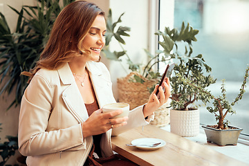 Image showing Coffee shop, phone and social media with a woman customer drinking while typing a text message by a window. Internet cafe, mobile and communication with a female enjoying a drink in a restaurant