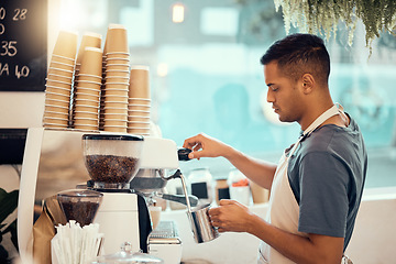 Image showing Coffee shop, barista and service with a man at work using a machine to pour a drink in the kitchen. Cafe, small business and waiter with a male employee working in a restaurant to prepare a beverage