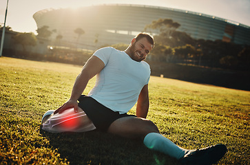 Image showing Fitness, leg injury and pain with a sports man stretching outdoor before a workout for health. Exercise, stretching and highlight with a male athlete suffering from inflammation or injured muscle