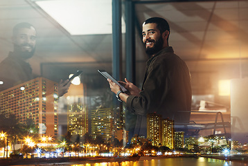 Image showing Night, city and portrait of man with tablet for global networking, stock market research and data analytics. Happy, window and lights of person smile for vision in trading, management or software app