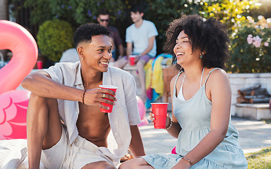 Image showing Summer, pool party and couple of friends with drinks outdoor with social celebration and happiness. Event, alcohol and young people relax on the floor talking with friend communication laughing