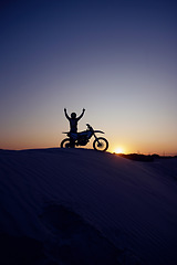 Image showing Motorcycle, sport and silhouette of man winner on bike at night for exercise, wellness or workout in nature. Fitness sports, health or motorbike person celebrate on desert dirt sand or hill mountain