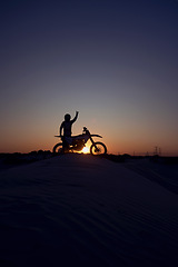 Image showing Motorcycle, success and person silhouette celebrating victory against a night, sky and background in nature. Sports, motorbike and biker stop for accomplishment, achievement and biking on dirt road