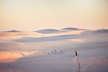 Image showing Desert, extreme moto cross and sports adventure athlete doing a jump with speed. Travel, sand and bike with energy of a man athlete cycling on dirt with challenge and sport race with freedom