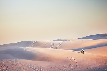 Image showing Sand landscape, motorbike or man on moto cross in desert space for sport workout, sunset ride or exercise on hill. Nature, sky or man riding for speed adventure in Dubai for training, fitness or race