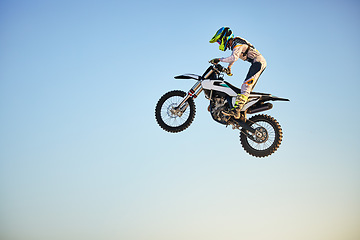 Image showing Motorbike, jump and person on blue sky mockup for training, competition and challenge with safety gear. Professional cycling, motorbike and adventure with speed, sports and danger on mock up space