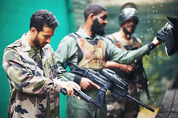 Image showing Military men, paintball gun and game, competition or sports challenge for battle, fight and survival. Soldier, army or warrior people shooting paint weapon in war training for battlefield protection