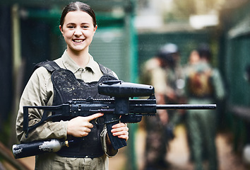 Image showing Paintball, happy and portrait of woman with gun in safety uniform for outdoor shooting game with smile. Excited tournament girl in vest protection ready for shooter sport and activity.