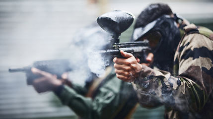 Image showing Paintball, sports and smoke with gun for shooting, action and military battlefield with soldier, war and fitness outdoor. People together in camouflage, mask with weapon and game, power and lifestyle