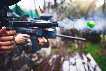 Image showing Explosion, shooting and person with paintball gun, ball and closeup of fun, extreme and sport, fitness and training. Zoom, marker, and target, practice and game with people competing