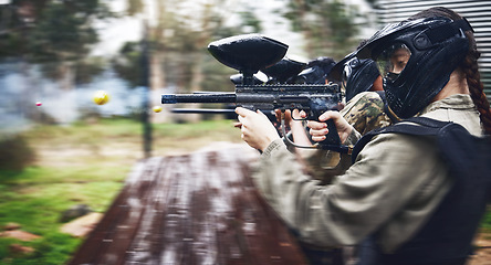 Image showing Paintball, soldier and action with gun for shooting, speed and military battlefield with sports, war and fitness outdoor. People together in camouflage, mask with weapon and game, power and lifestyle