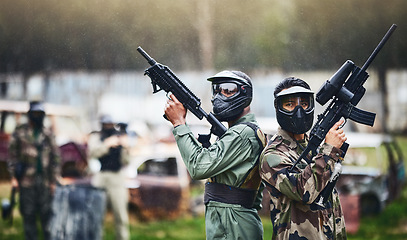 Image showing Paintball, ready or people in a gun shooting games with war action in playground battlefield on holiday. Military mission, team or players with weapons gear for survival to start outdoor competition