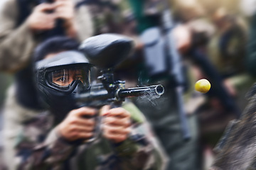 Image showing Paintball gun zoom, smoke and shooting with action, speed and military battlefield with soldier, war and fitness outdoor. People together in camouflage, mask with weapon and game, power and sports