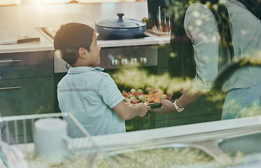 Image showing Cooking, vegetables and child helping mother with food, preparation and learning by oven in kitchen. Breakfast, happy and mom and boy kid making lunch, dinner or a snack together in their family home