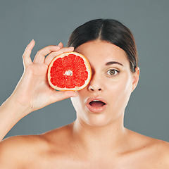 Image showing Skincare woman with grapefruit portrait or wow face for health wellness, aesthetic or facial product. Healthy vitamin C, healthcare or nutrition with beauty, luxury or food in hand of model in studio