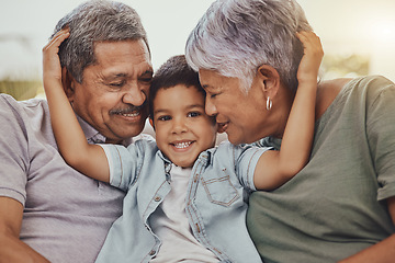 Image showing Family, portrait and child with grandparents in a living room, hug and happy, love and sweet while bonding in their home. Embrace, grandchild and grandmother with grandfather in a lounge hugging