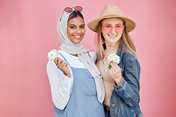 Image showing Friends, diversity and fashion women portrait with spring flowers on a pink background with a happy smile. Muslim woman and girl together for hug, love and support for lgbt freedom, respect and pride