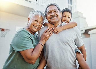 Image showing Piggyback, love and portrait of grandparents with a child in the backyard of their family home. Happiness, smile and elderly man and woman in retirement bonding with grandson outdoor their house.