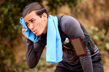 Image showing Fitness, health and man sweating while running on mountain for exercise or training for race or marathon. Sports, woods and tired male athlete or runner on break while doing cardio workout in nature.