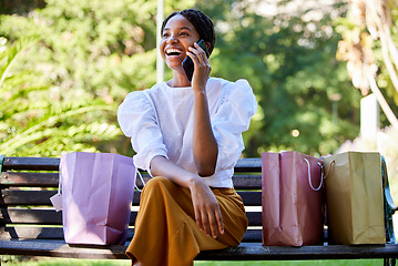 Image showing Phone call, happy or black woman with shopping, luxury sale or retail bags in Paris park with smile. 5g network, fashion or girl with smartphone for comic communication or networking in city bench