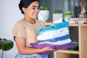 Image showing Laundry, housework and towels with a woman cleaner working in a home for domestic hygiene as a maid. Cleaning, hospitality and fabric with a female housekeeper at work in a hotel room or house