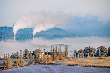 Image showing industrial cityscape with with smoking factory