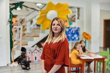 Image showing Portrait of a teacher in a preschool institution, in the background of the classrooms